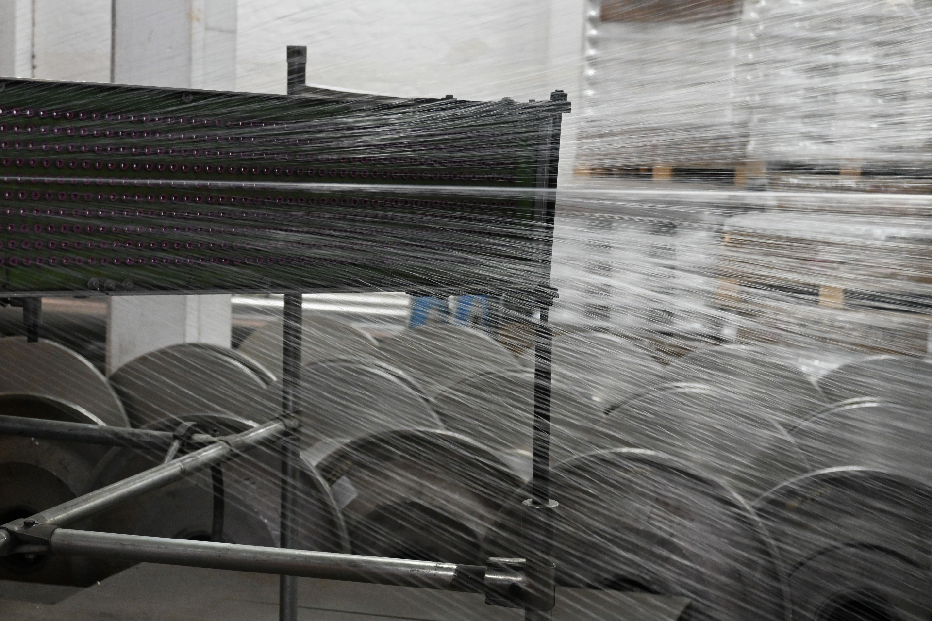 Close-up of warp threads feeding from beam creel into knitting head
