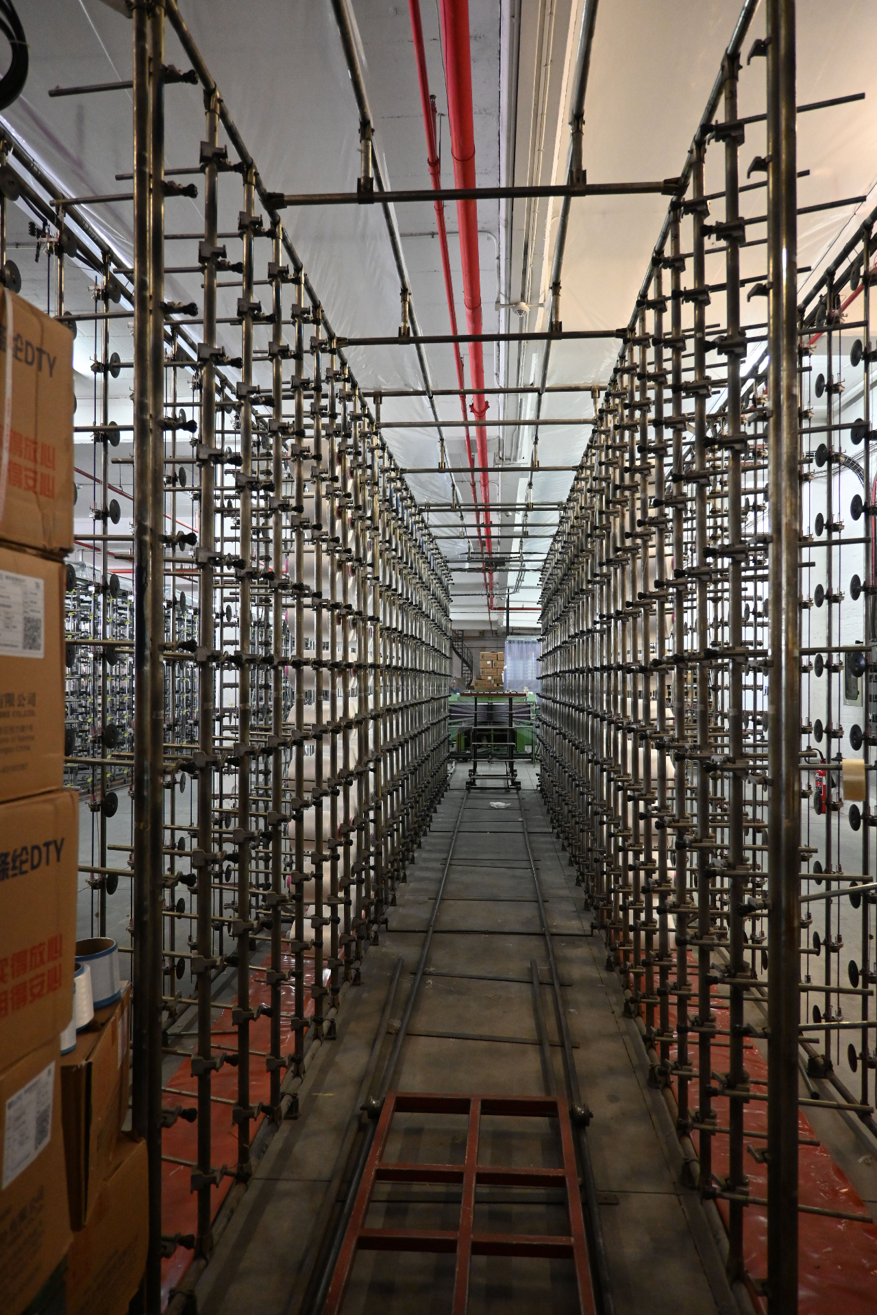 Long aisle through the creel rack system feeding the knitting line